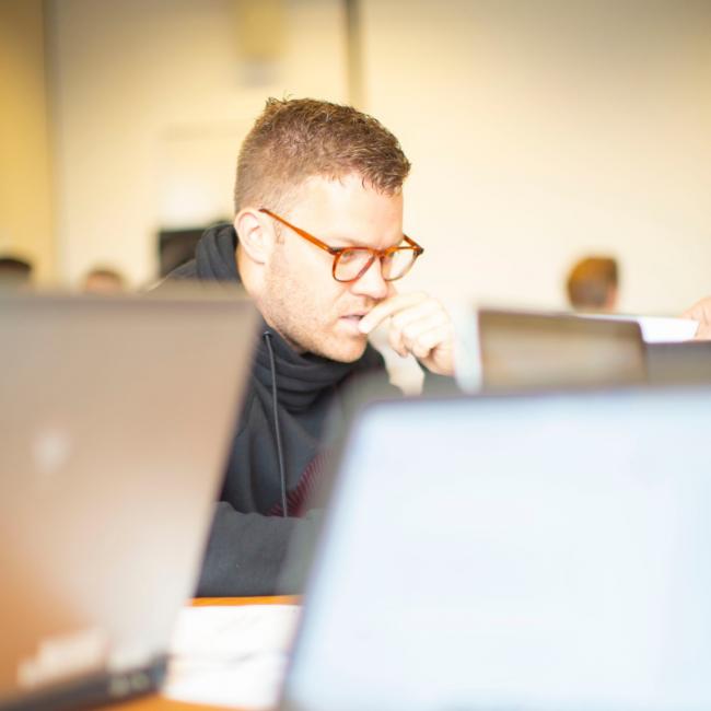 Person-looking-at-laptop-screen-in-class