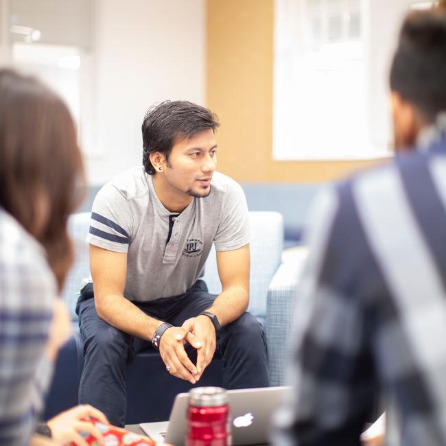 Students-sitting-together-with-laptop-open