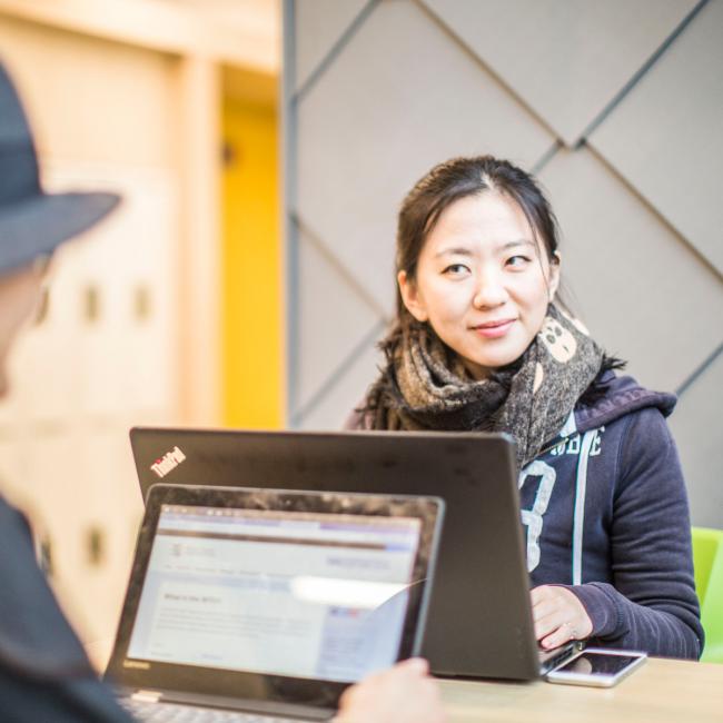 Person working on laptop looking interested and positive