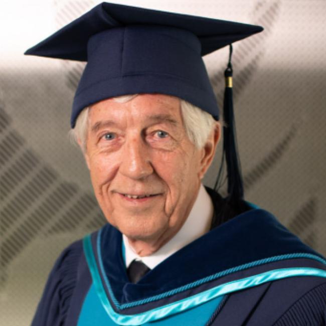 Dan Miller wearing Royal Roads University convocation regalia.