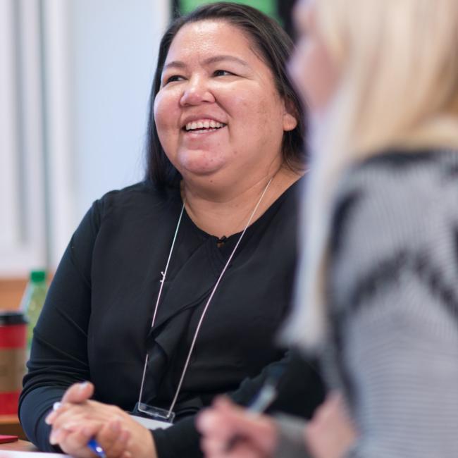 A smiling Indigenous student in the classroom.