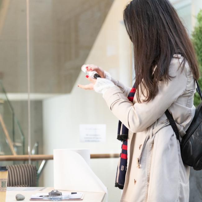 A student applies hand sanitizer.