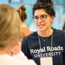 Student-with-Royal-Roads-University-sweatshirt-and-lanyard