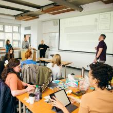 Students-and-instructors-in-classroom-with-large-whiteboard