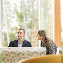 Two-students-sitting-together-in-front-of-window