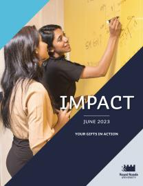 The cover of Impact. Two women work together, drawing on a yellow marker board. Slashes of RRU blues cross the page.