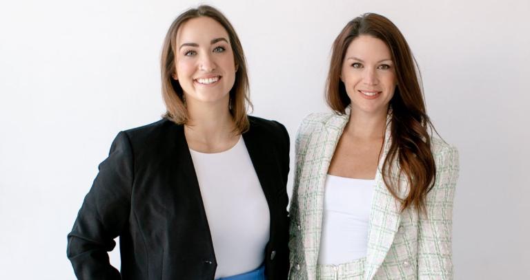 Marissa McNeelands (left) and April Hicke (right) stand in front of a white background